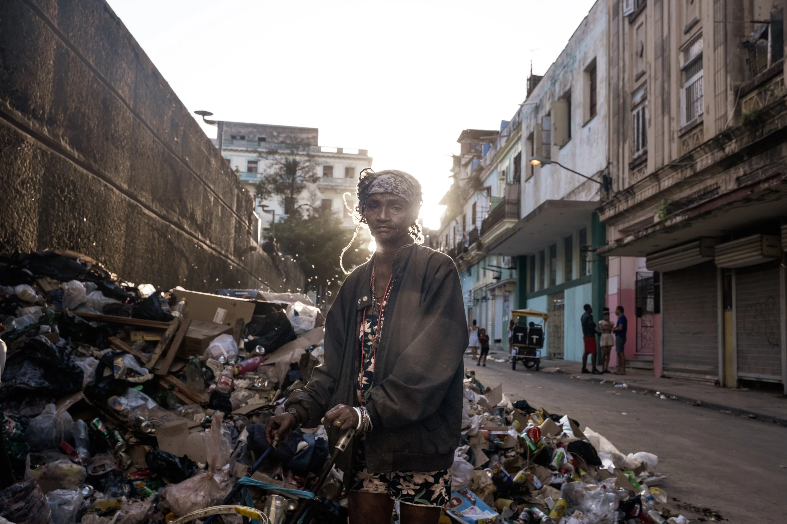 Santa, 60, searches for food and other usable items among garbage left on a street in Havana