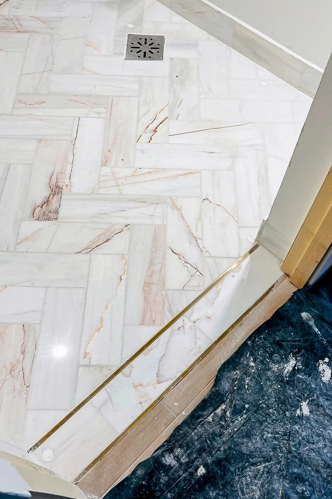 Herringbone marble and brass transitions