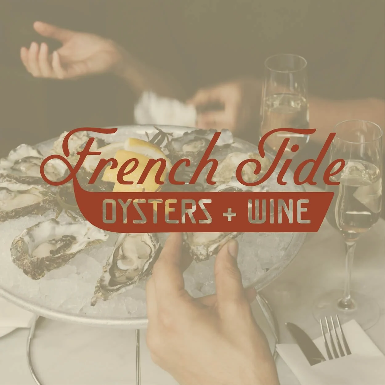 French Tide oysters and wine semi custom brand logo overtop an image of a plate full of fresh oysters and glasses of white wine