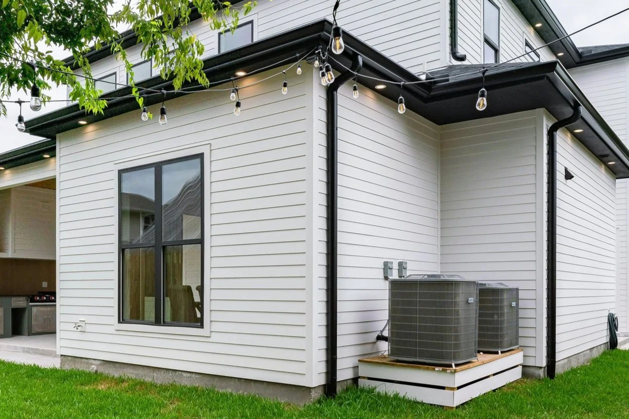 Dual HVAC heat pump units outside a California home, offering certified energy-efficient installation and rebates.