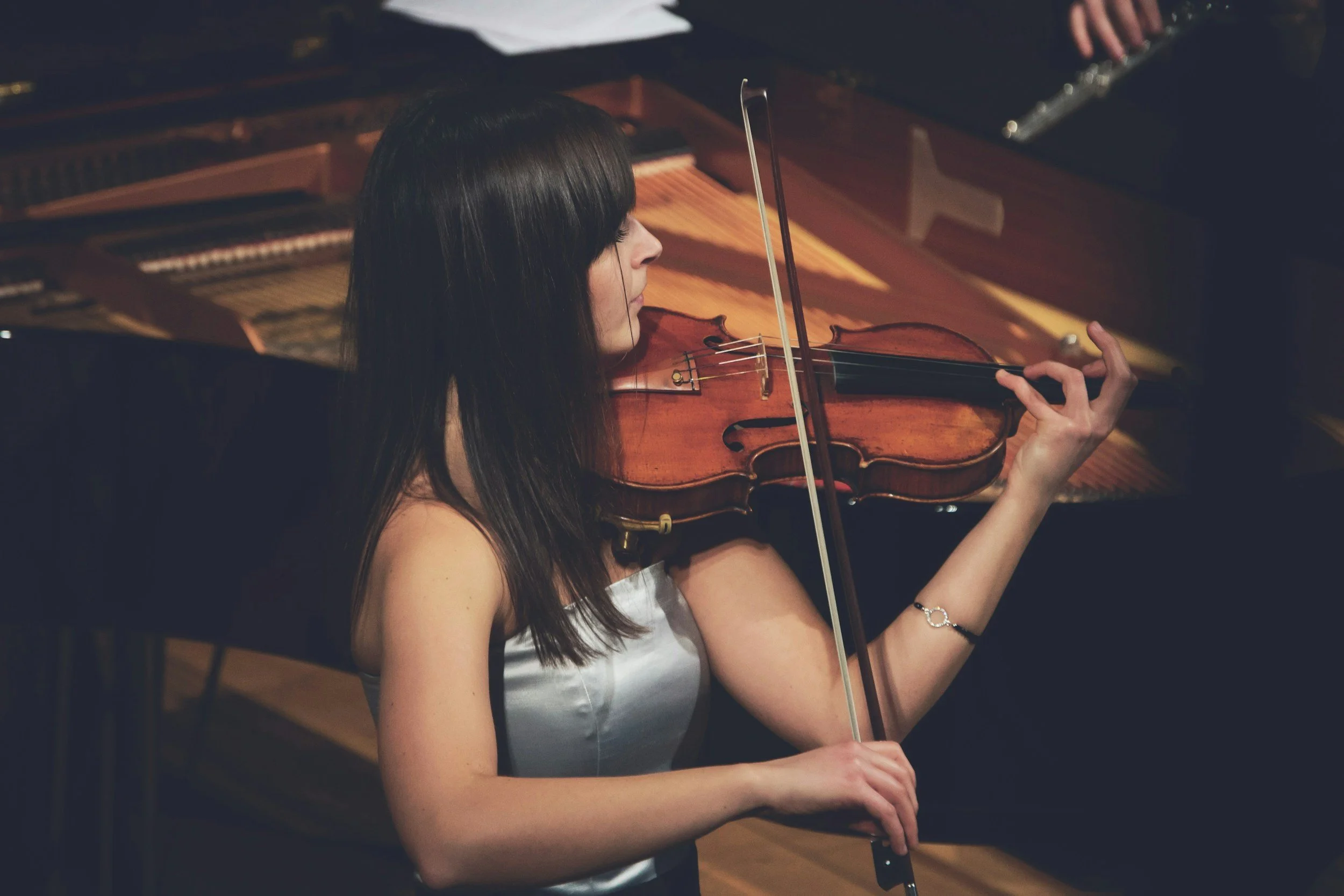 A violin teacher playing a violin