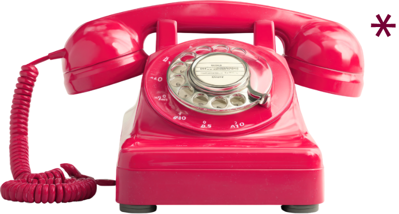 A vintage pink rotary telephone with a coiled cord and circular dial.