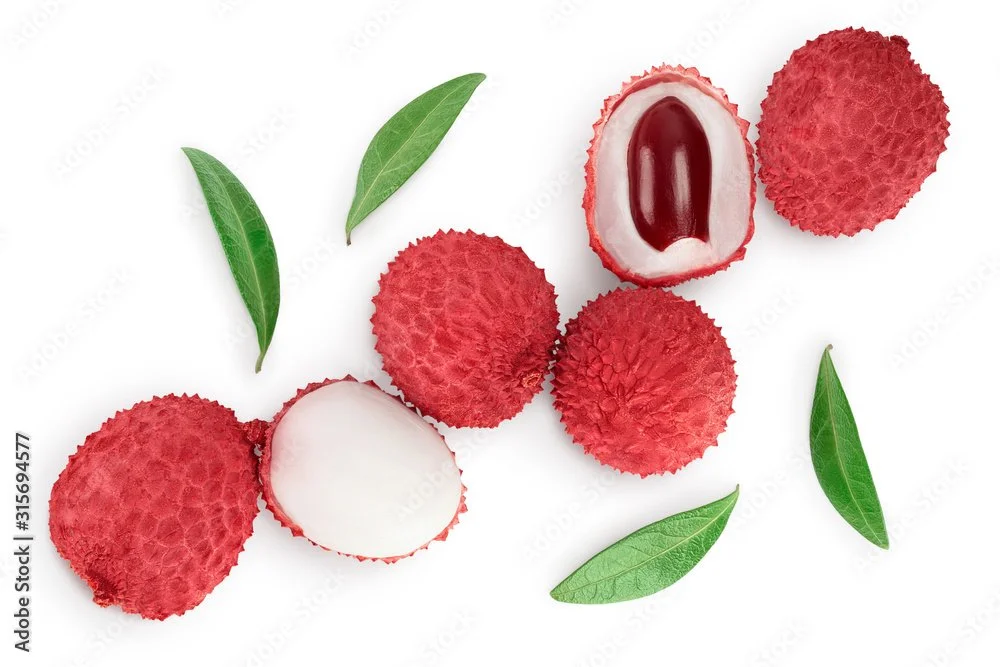 Whole lychee fruits, some peeled showing the white flesh and seed, along with green leaves.