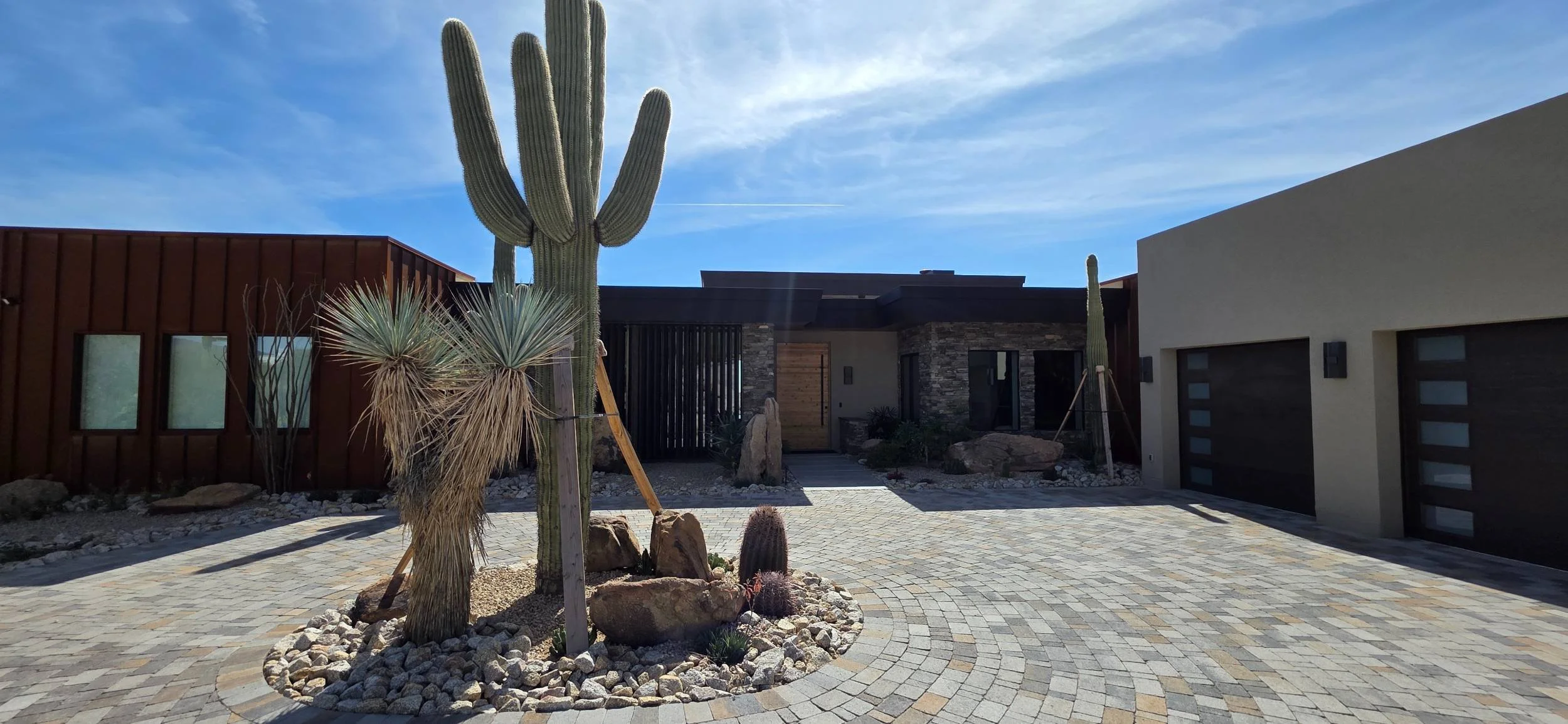 A custom outdoor living space with patio pavers and fire features in Carefree, AZ
