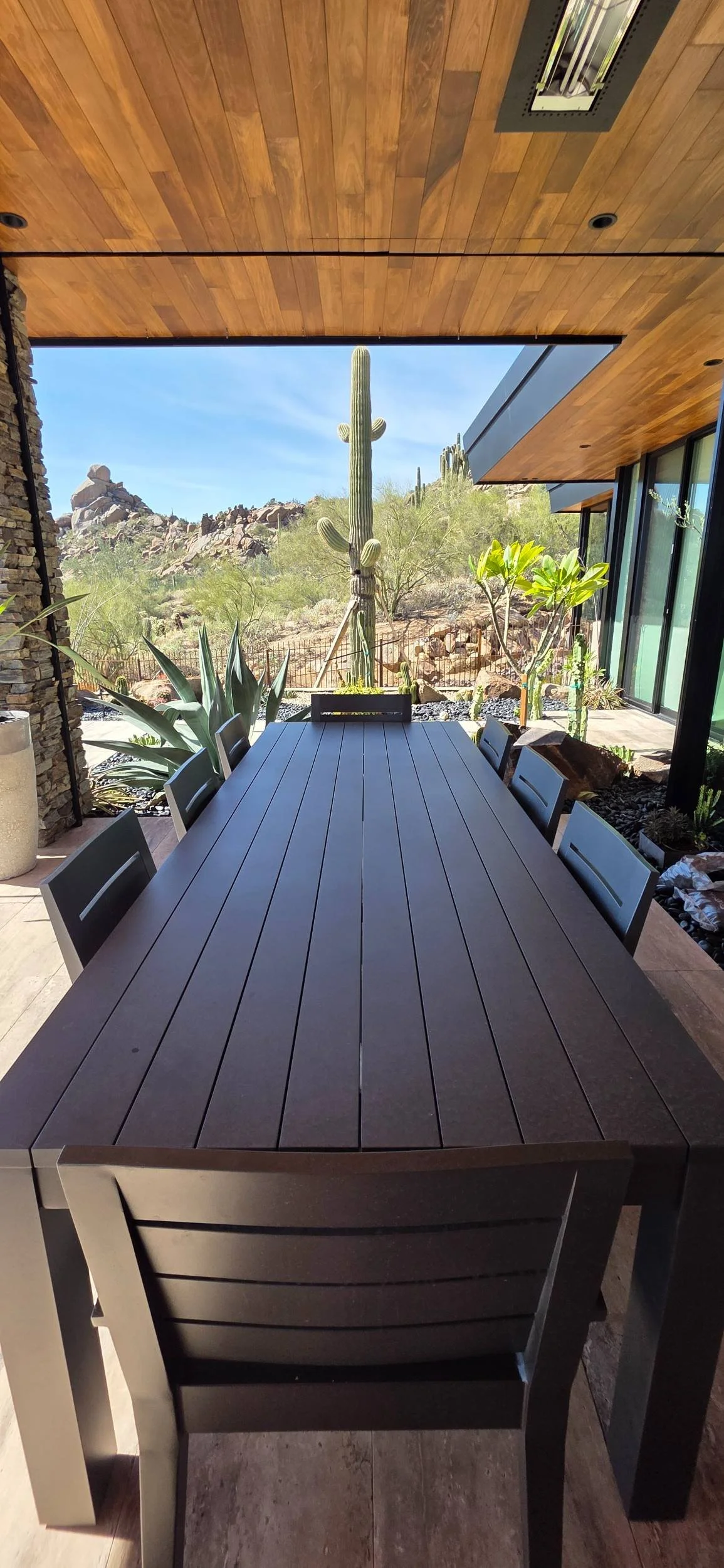 A beautiful outdoor kitchen and poolscape designed for entertaining in New River, AZ