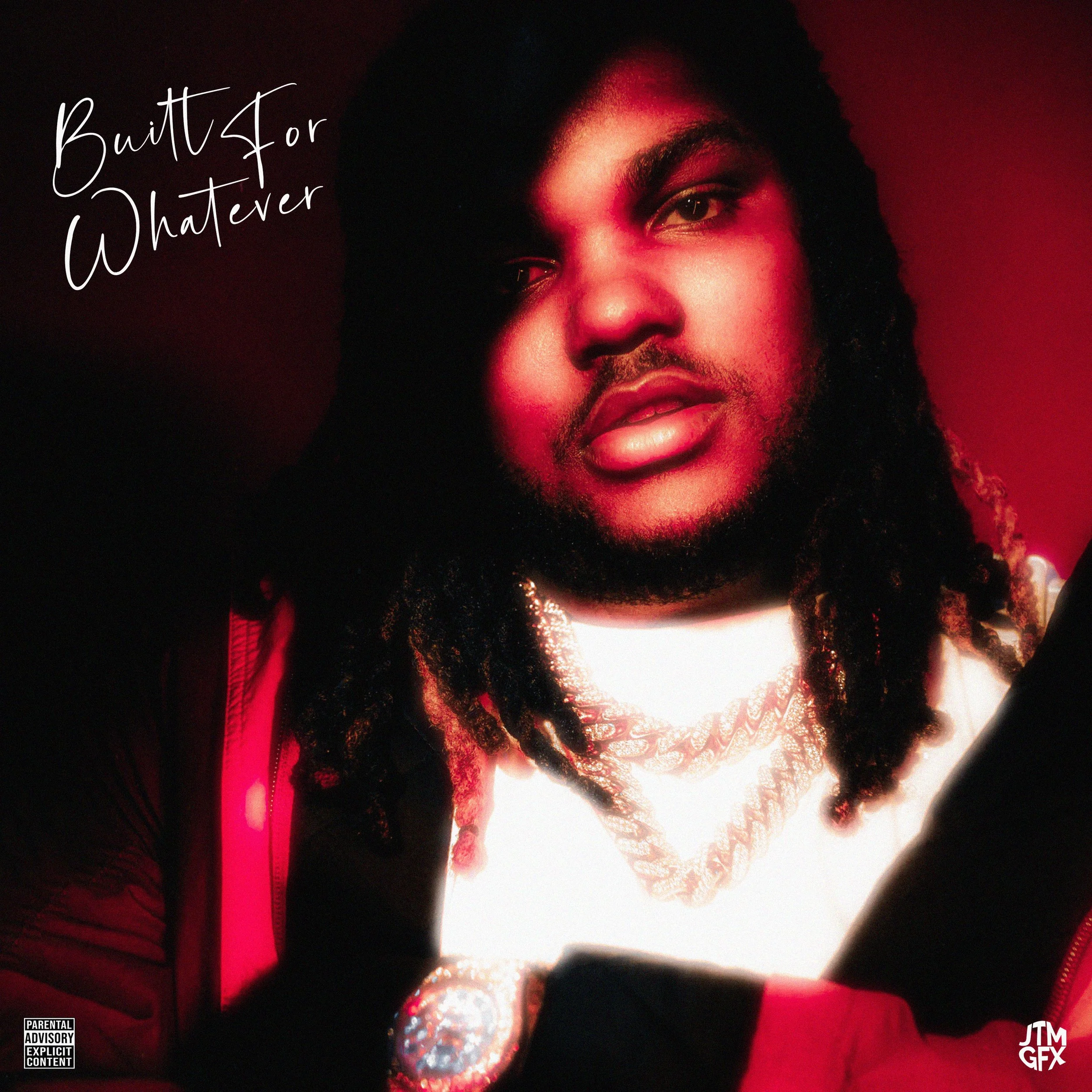 Close-up of a man with dreadlocks, wearing a gold chain and jewelry, against a red background, with the text 'Built for Whatever' in the top left corner.