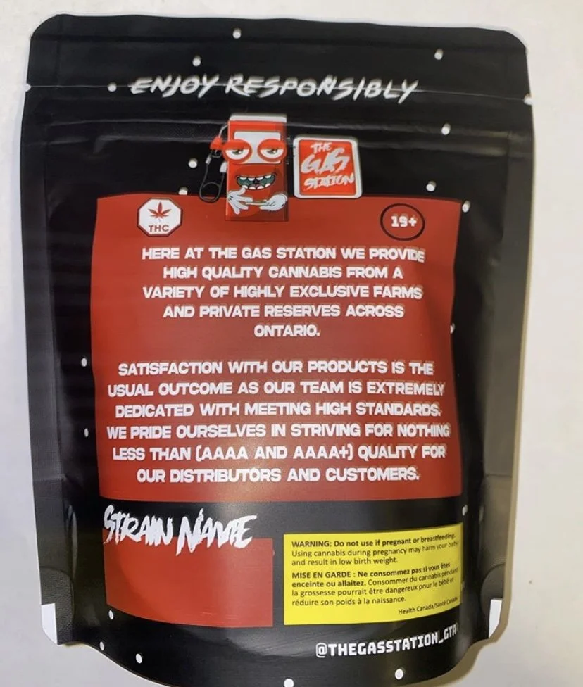 A black and red cannabis product package from The Gas Station, featuring a cartoon gas pump character with sunglasses and a grin. The package contains high-quality cannabis and has a warning label about not using during pregnancy. The text emphasizes