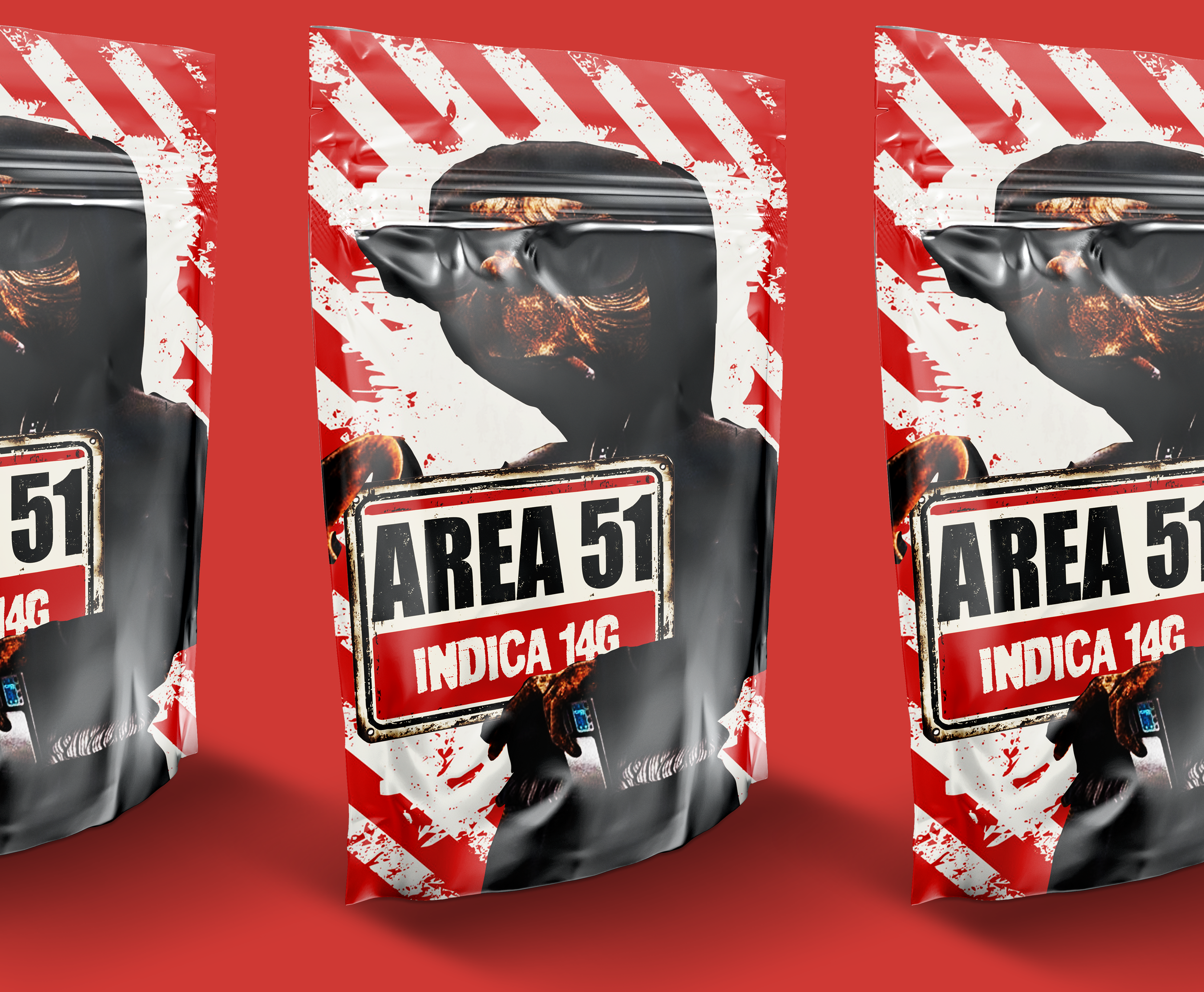 Three packages of cannabis labeled 'Area 51' with 'Indica 14G' written on them, featuring a stylized image of a humanoid alien with a large head and sunglasses against a red and white striped background.