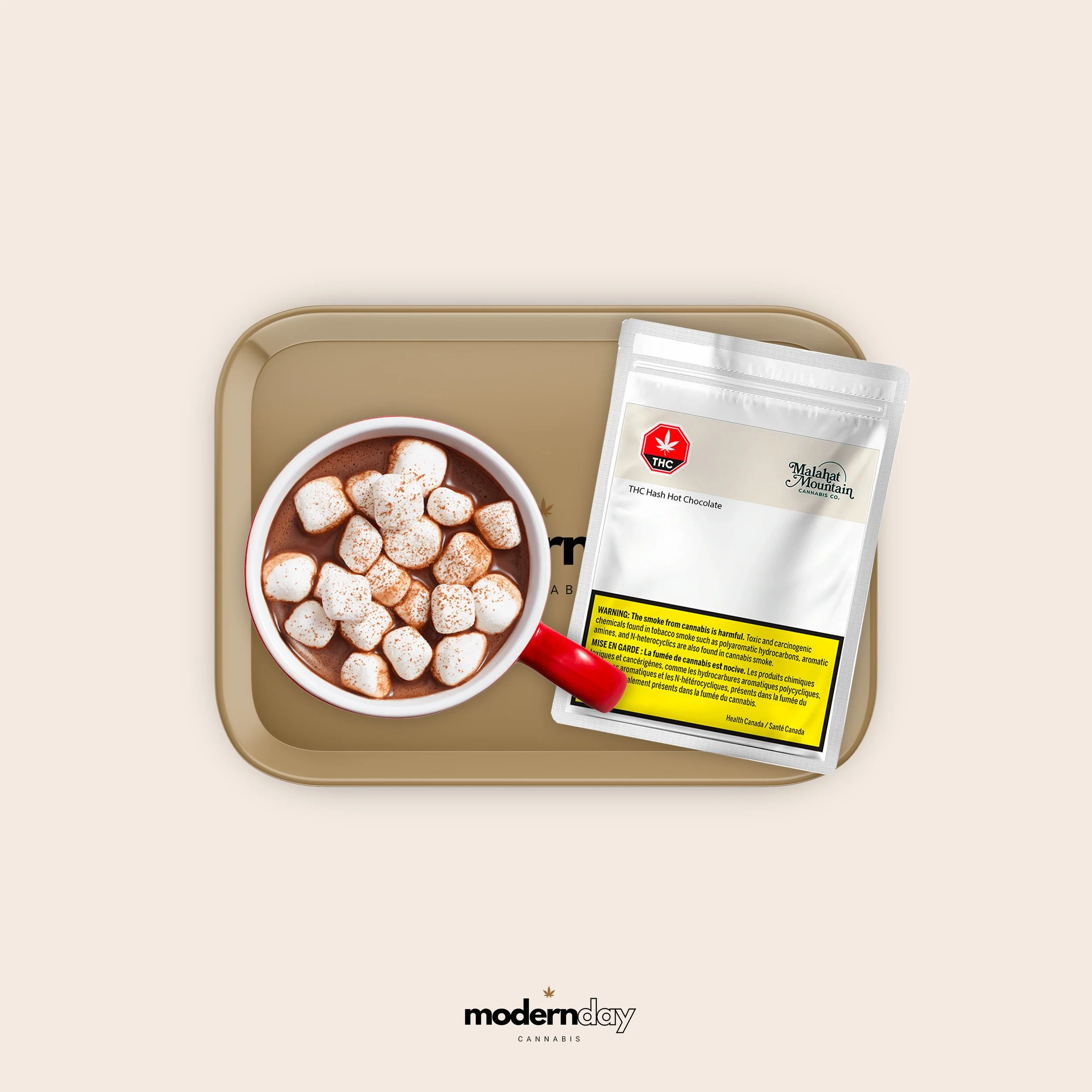 A tray with a cup of hot chocolate topped with mini marshmallows and a bag of THC hash hot chocolate mix from Malahat Mountain Cannabis.