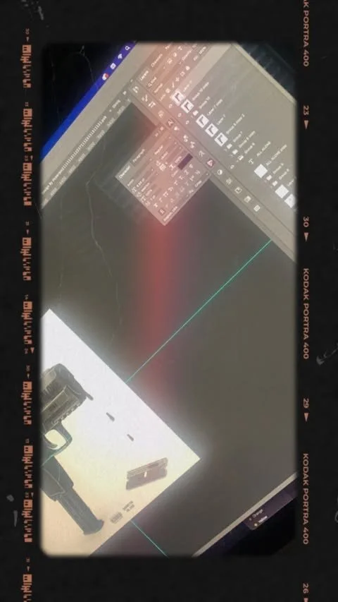 Computer screen displaying digital art with a gun, and a digital editing interface with multiple tools and layers.