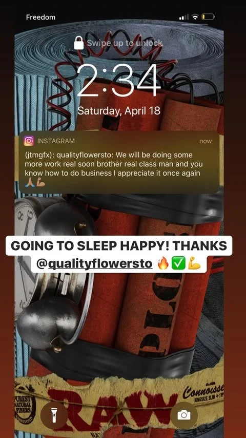 A smartphone lock screen displaying the time 2:34 on Saturday, April 18, with a notification from Instagram from qualityflowersto expressing appreciation for work done and sharing plans to work on a class project. The background shows a close-up of a