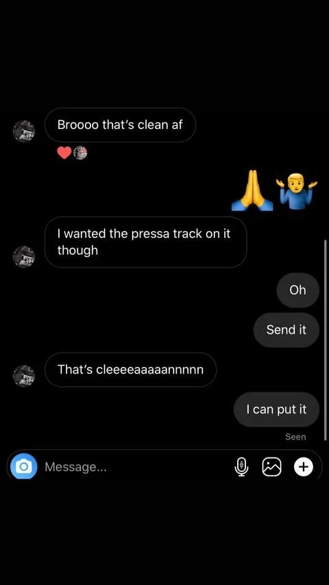 Screenshots of a text conversation on a messaging app with comments about a clean record and requesting a press track, including emojis and a camera icon at the bottom.