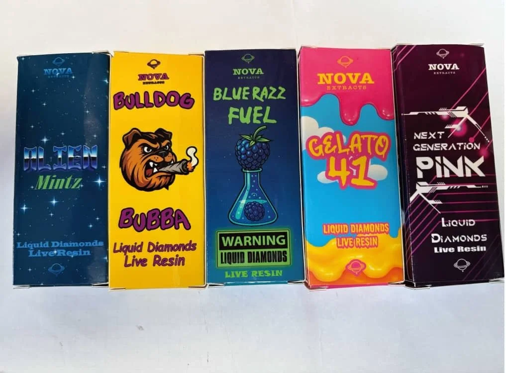 Six colorful boxes of Liquid Diamonds Live Resin products, each with distinct designs and names like Alien Mintz, Bulldog Bubba, Blue Razz Fuel, Gelato 41, and Pink Next Generation.