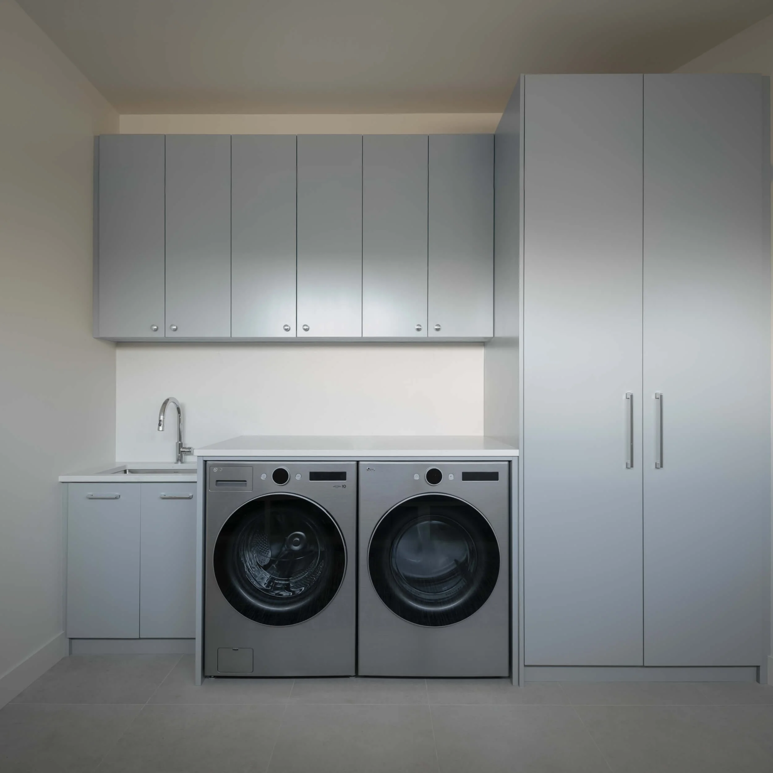 schmidt-residence-invermere-laundry-room-blue-grey-cabinetry-architectural-photographer-matt-anthony.jpg