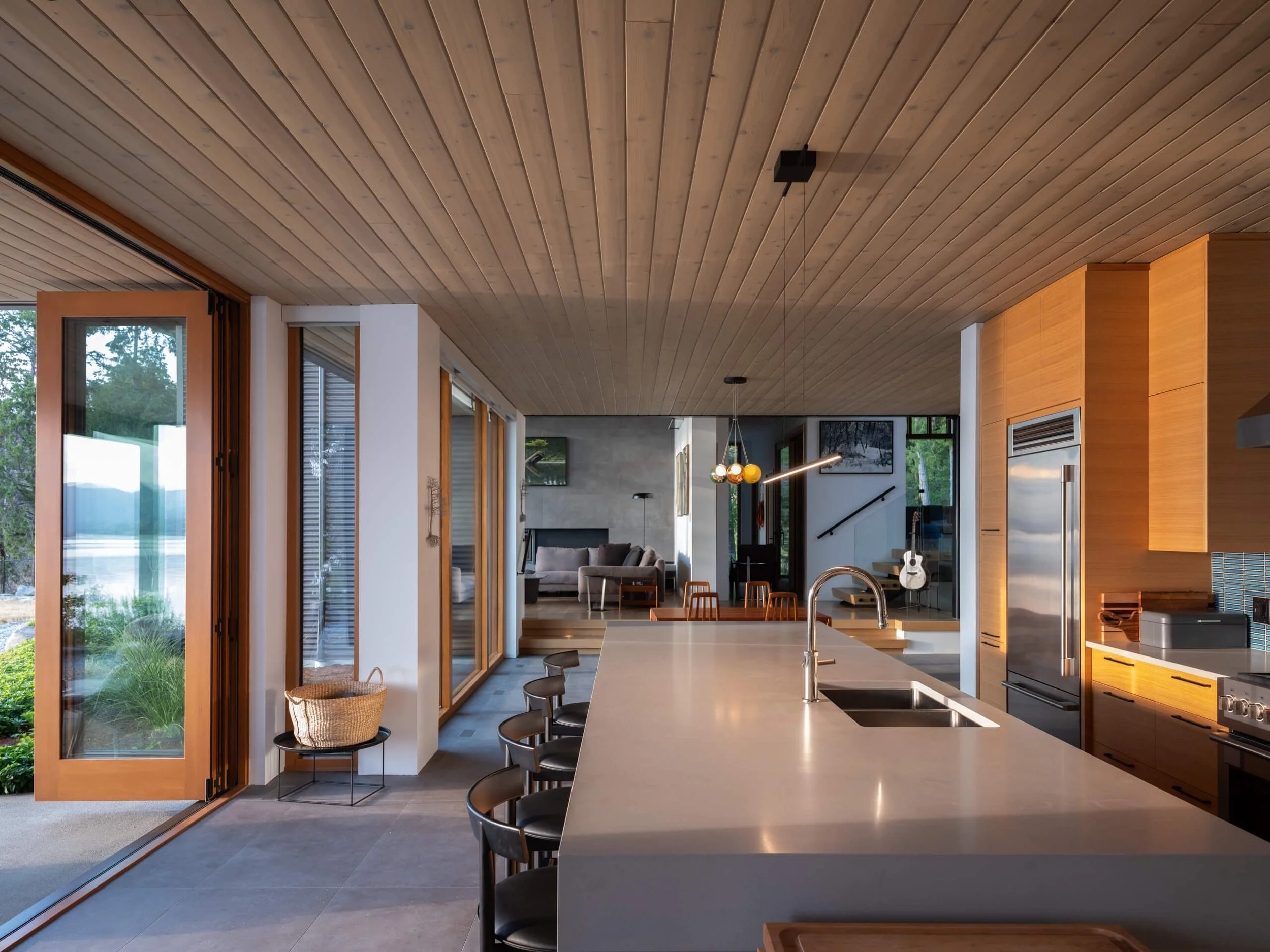 salt-spring-island-residence-kitchen-with-folding-glass-doors-open-architectural-photographer-matt-anthony.jpg