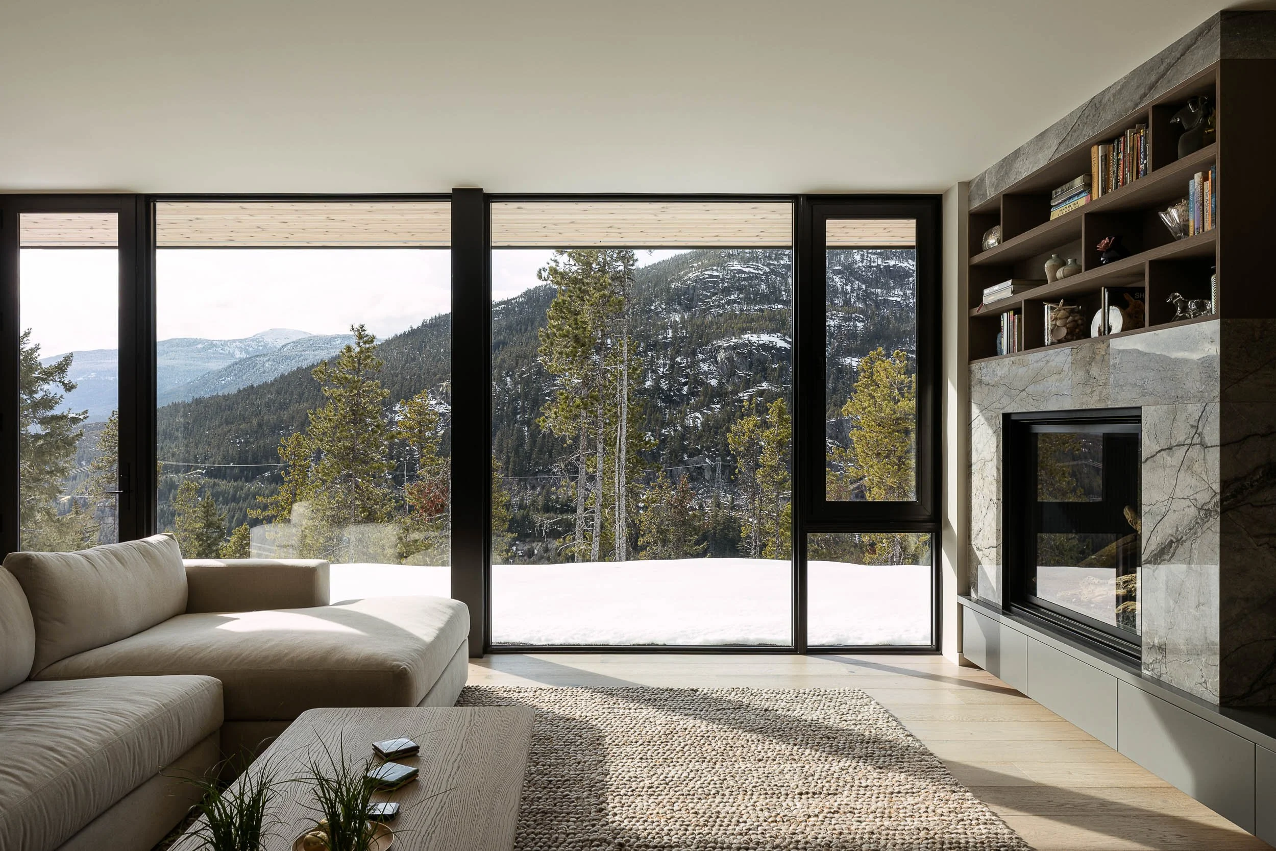 Warbler Residence warm interior with fireplace and timber details in soft winter light