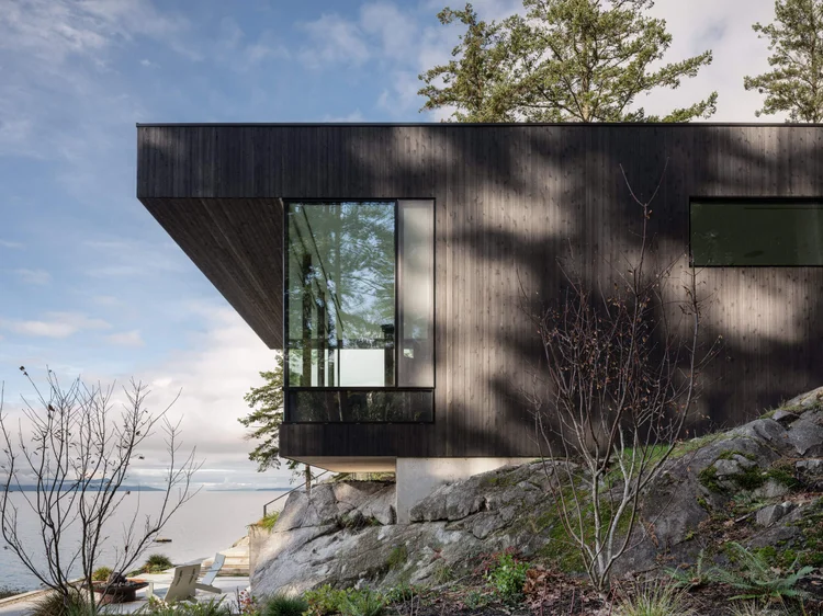 The Perch, Sunshine Coast, a dark clad corner projecting out over rock, the sea and low cloud beyond