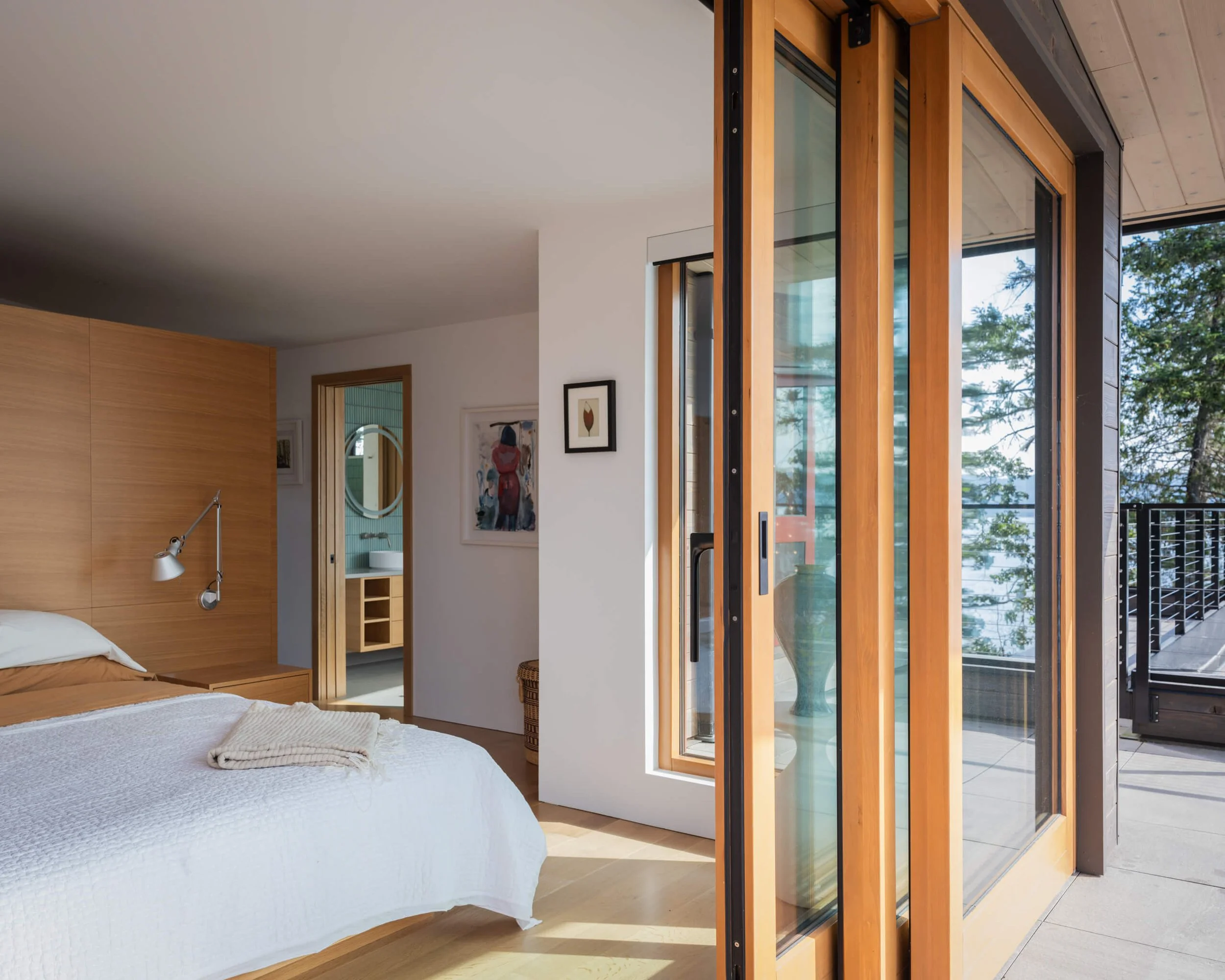 salt-spring-island-residence-primary-bedroom-sliding-doors-to-deck-architectural-photographer-matt-anthony.jpg