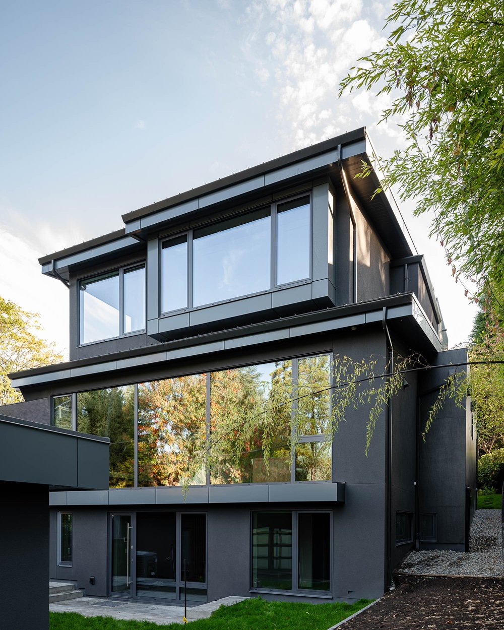 Rear elevation of three storeys, an upper glazed bay under a sloping roof