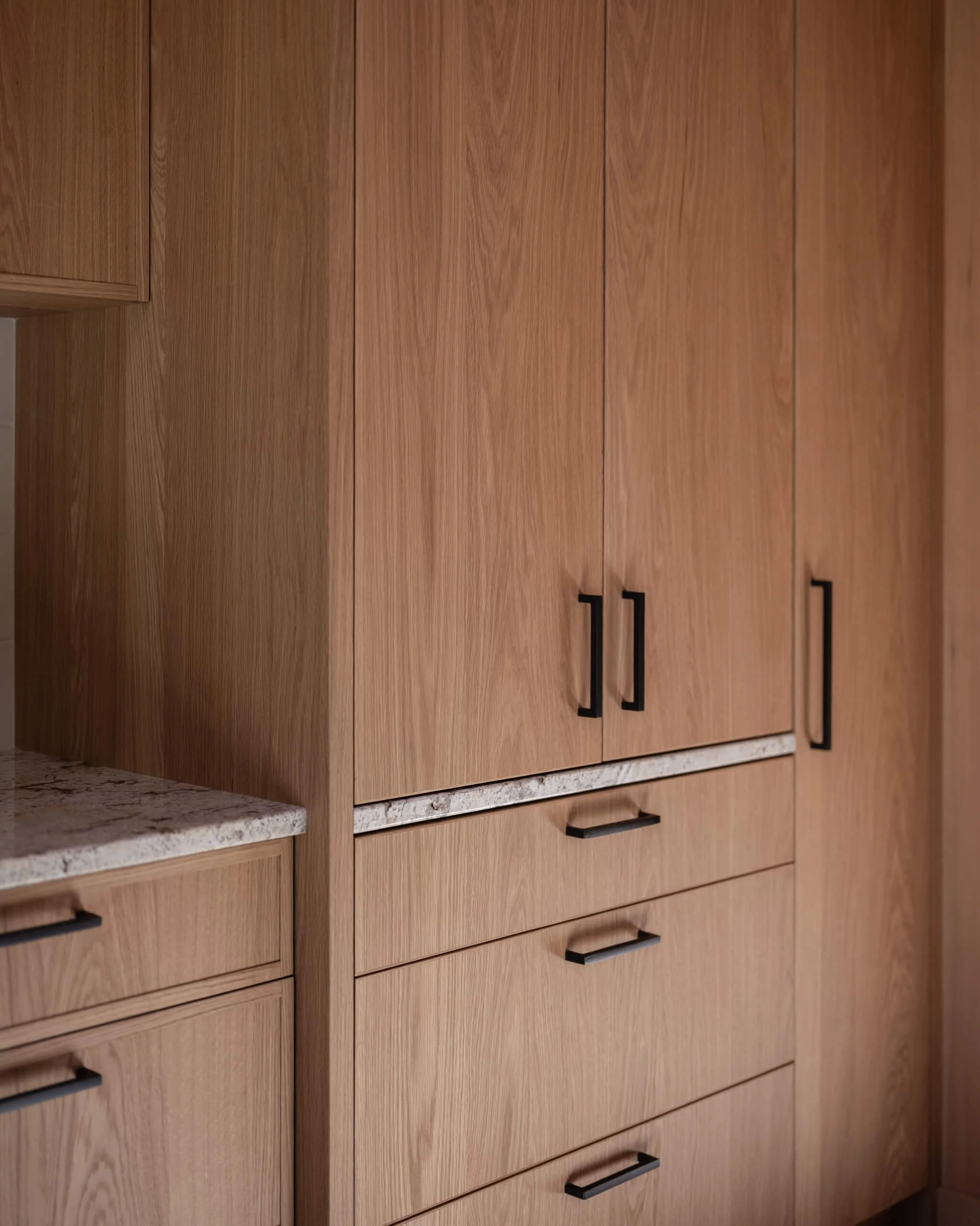 desolation-sound-residence-white-oak-storage-wall-black-pulls-architectural-photographer-matt-anthony.jpg