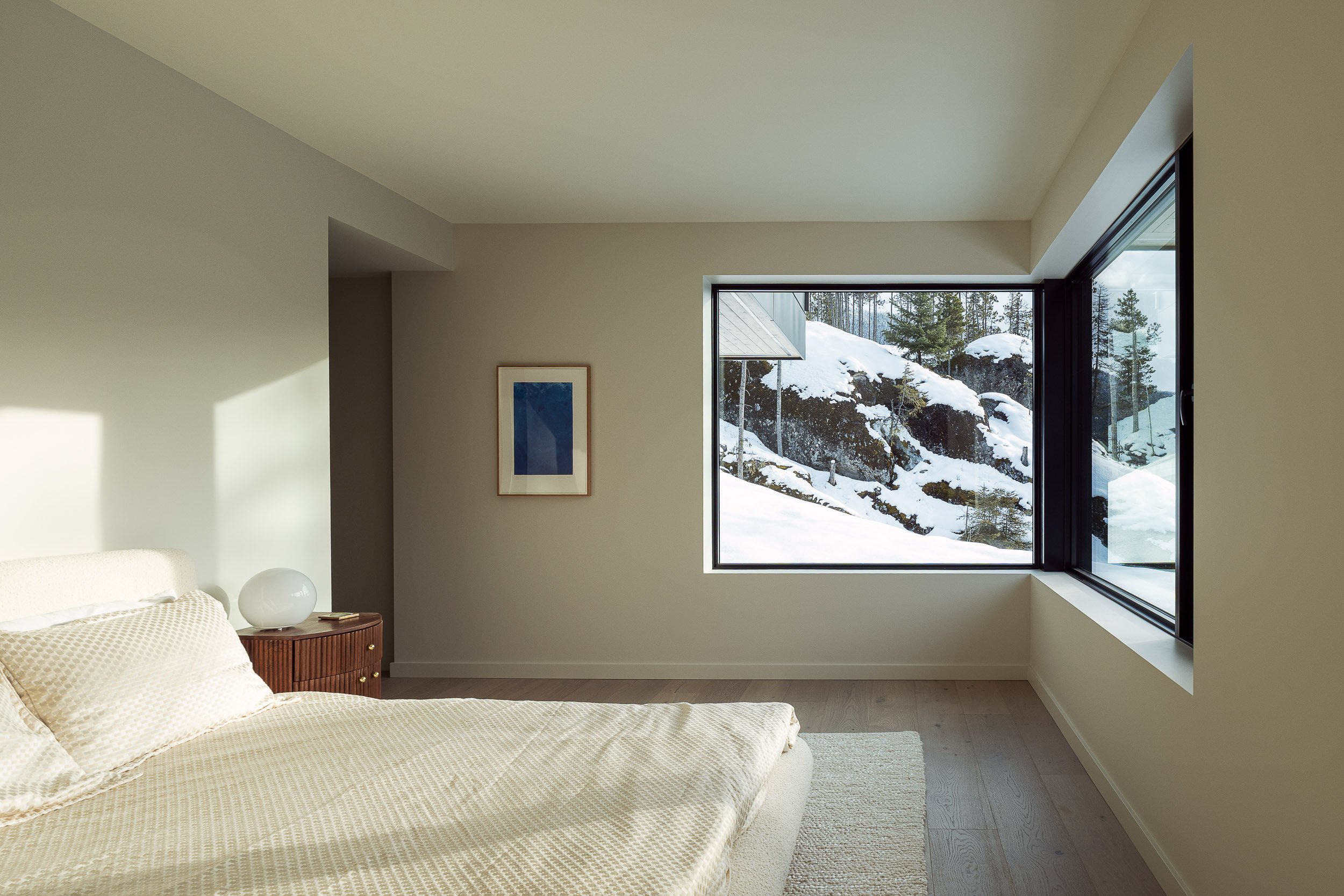 Snow-covered alpine residence in Whistler photographed at twilight during winter season