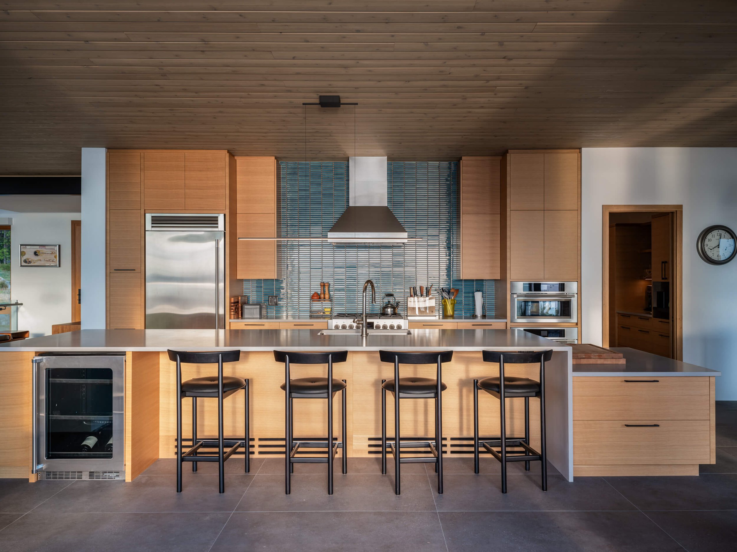 salt-spring-island-residence-kitchen-elevation-island-stools-architectural-photographer-matt-anthony.jpg
