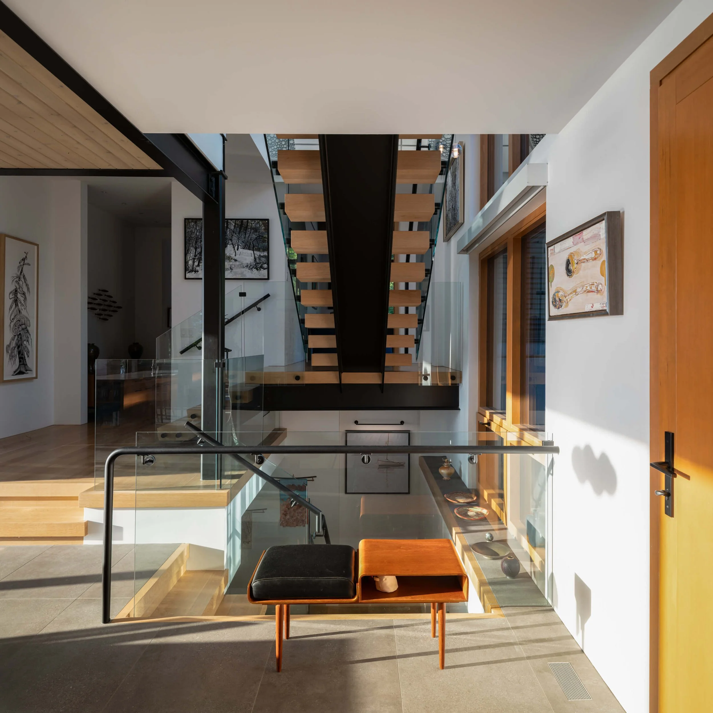 salt-spring-island-residence-entry-hall-bench-and-open-stair-architectural-photographer-matt-anthony.jpg
