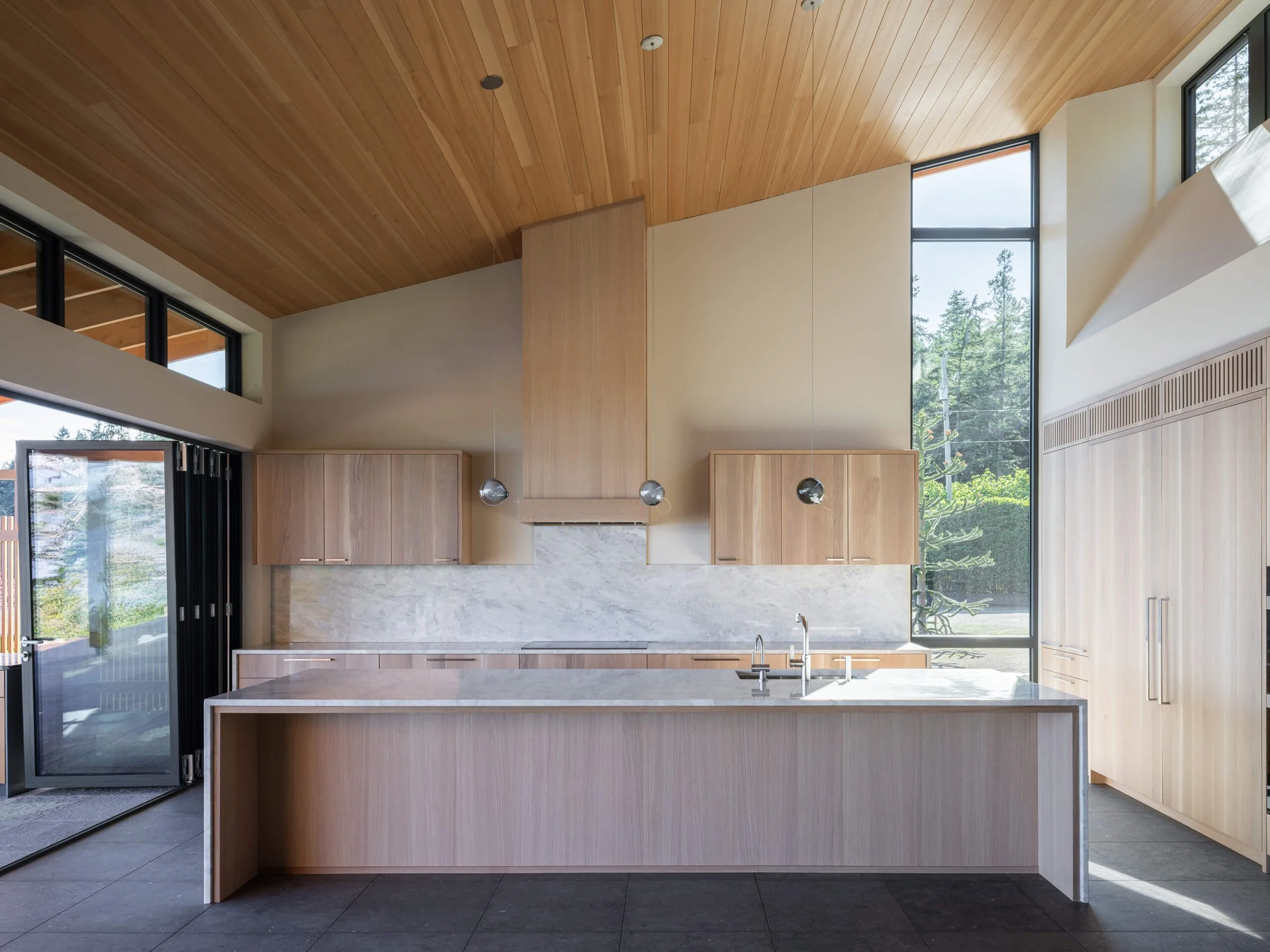 desolation-sound-residence-kitchen-island-under-the-vaulted-ceiling-architectural-photographer-matt-anthony.jpg