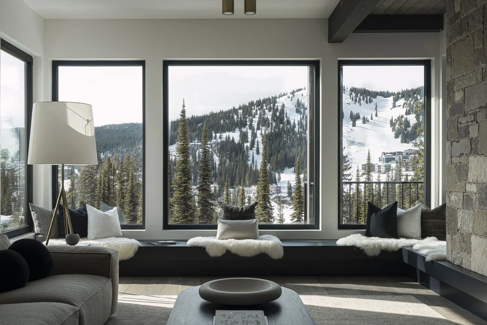 Living room windows onto the ski runs, window seat with white fleece throws