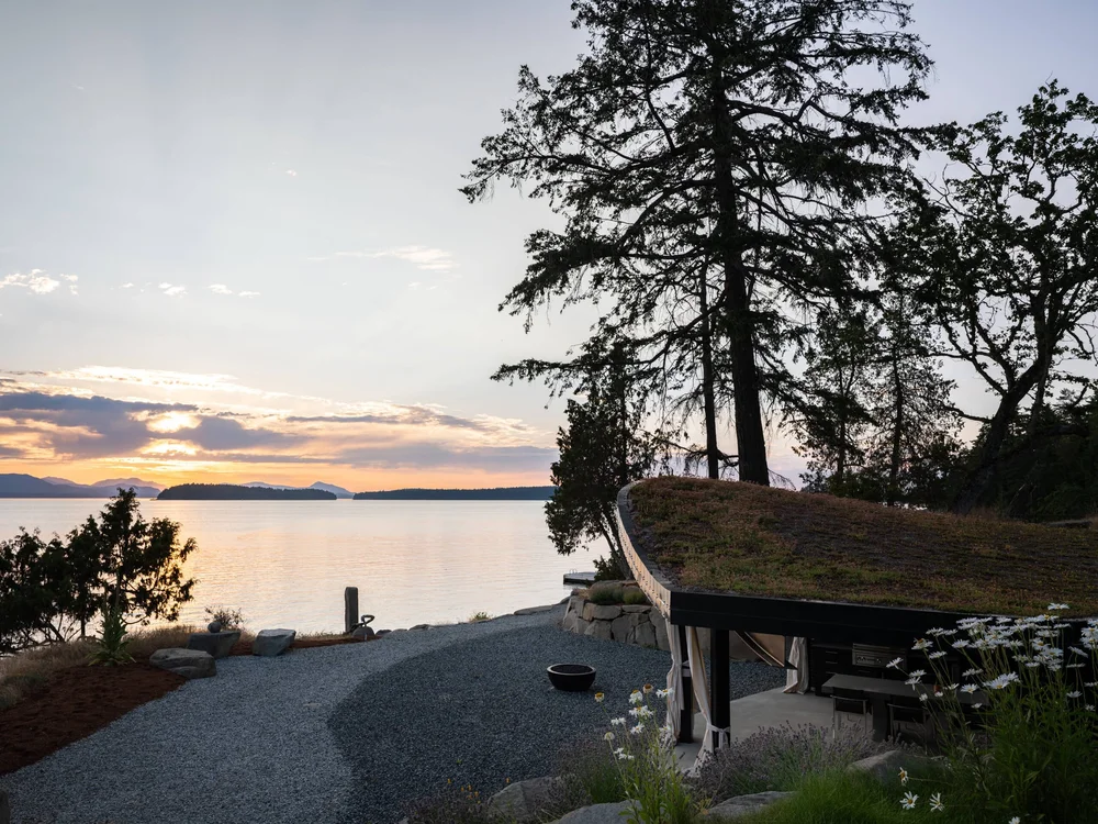 The shore path at sunset, the pavilion roof curving in at the right edge