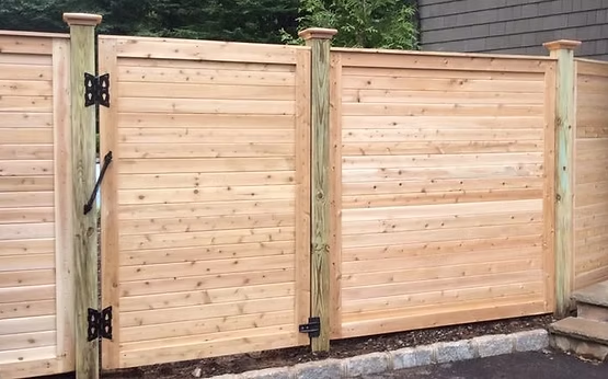 Select Series W303 wood fence with horizontal plank pattern and framed gate in Pequannock, NJ