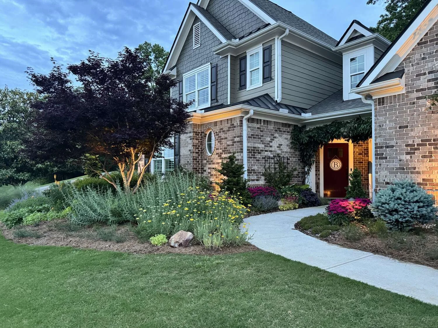 Front yard landscape design with natural stone walkway in Suwanee, GA
