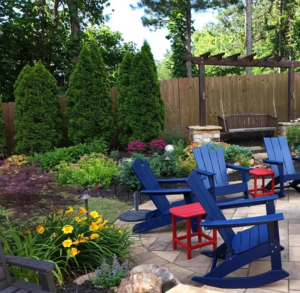 Backyard seating area in Buford, GA with stone patio, garden steps, and fire pit by trusted hardscape company
