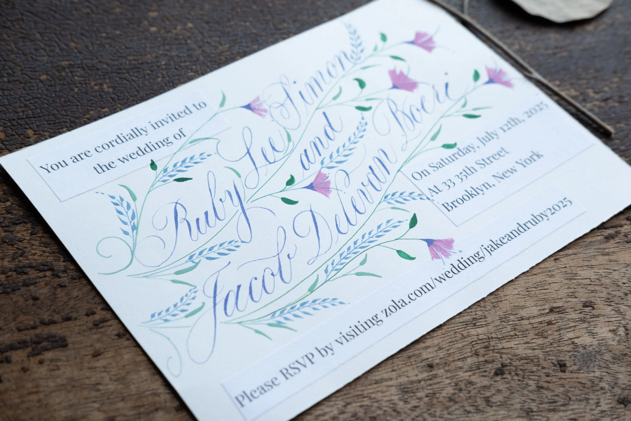 ruby invite mock-up on wood.jpg