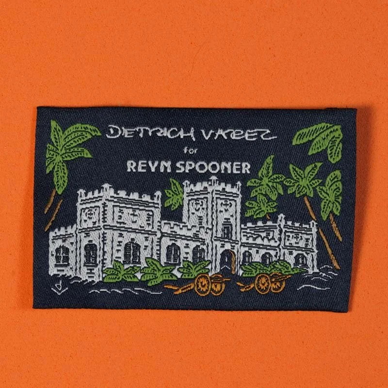 A patch featuring a white castle with palm trees and cannons, with text 'Dutch Vaper for Reym Spooner' on a dark background.