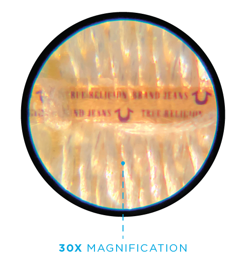 Close-up view through a microscope showing a band of latex condoms, with visible text 'REJECTION AND JEANS' and recycling symbols.