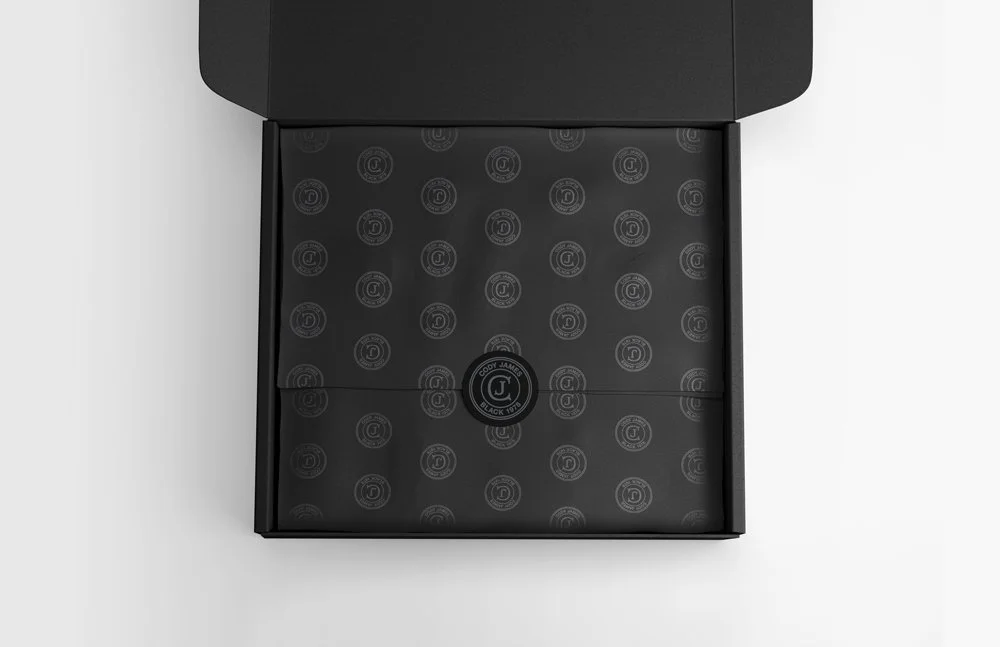 Black box with Cody James logo on black paper inside