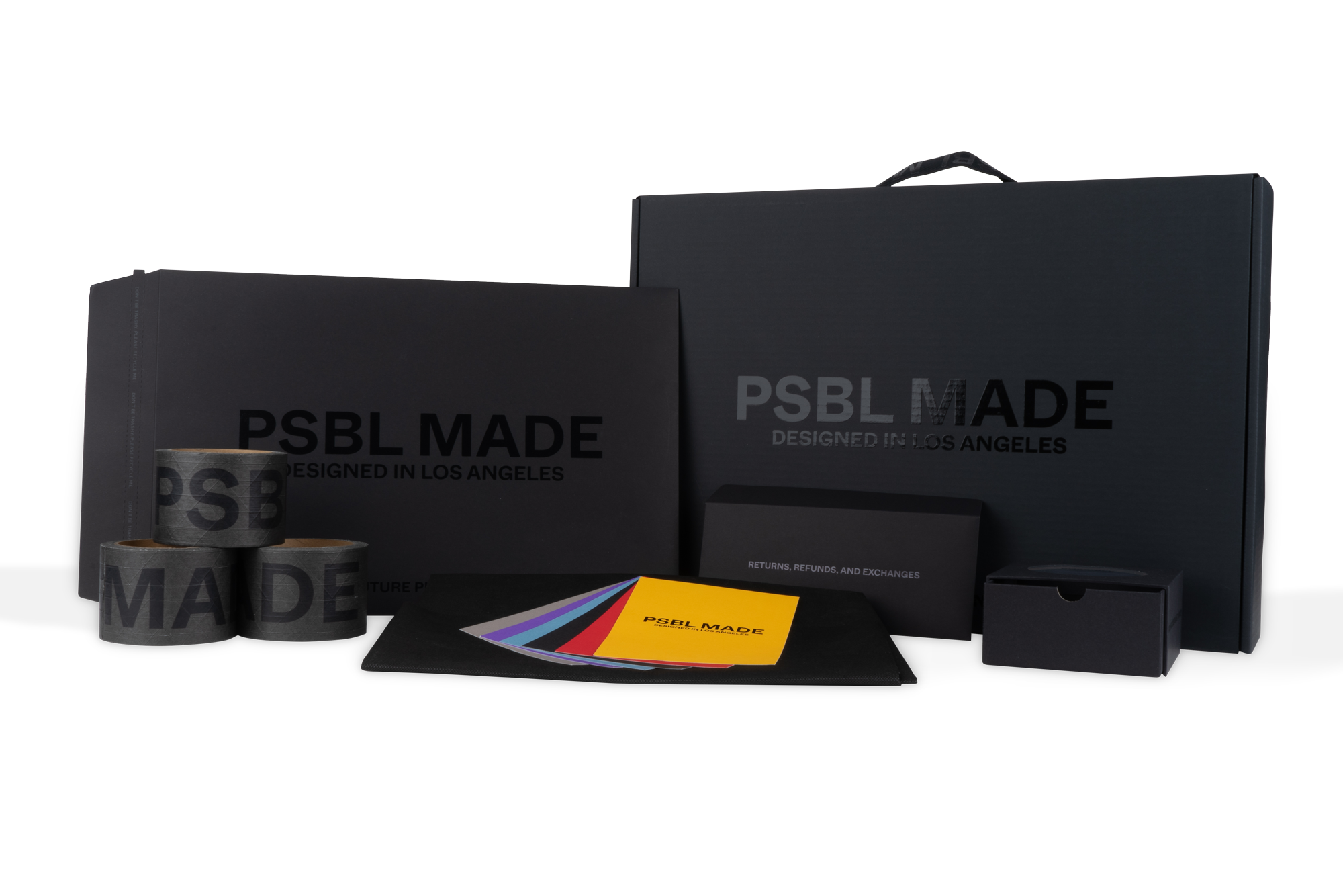 Various black packaging with 'PSBL MADE' branding, including boxes, tape rolls, booklets, color swatches, and a small drawer box, designed in Los Angeles.