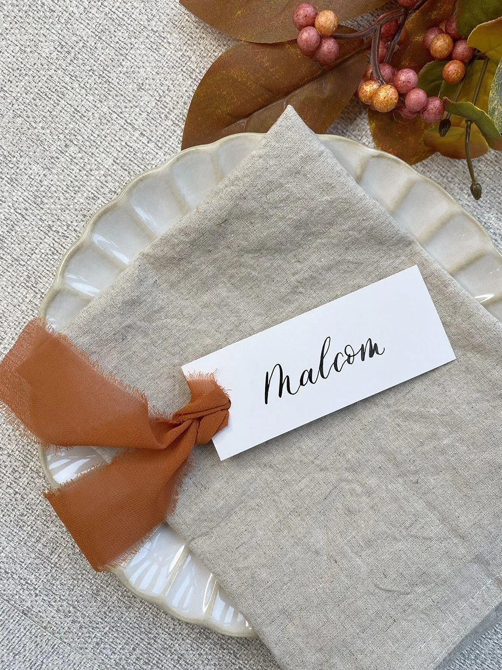 Black-calligraphy-place-cards-on-White-orangeribbon.jpg