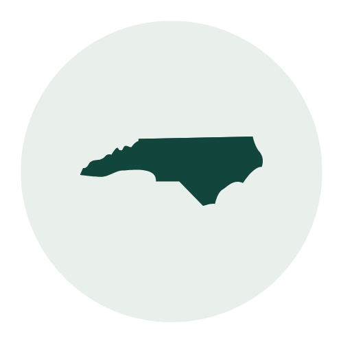 Silhouette of the state of North Carolina on a circular background
