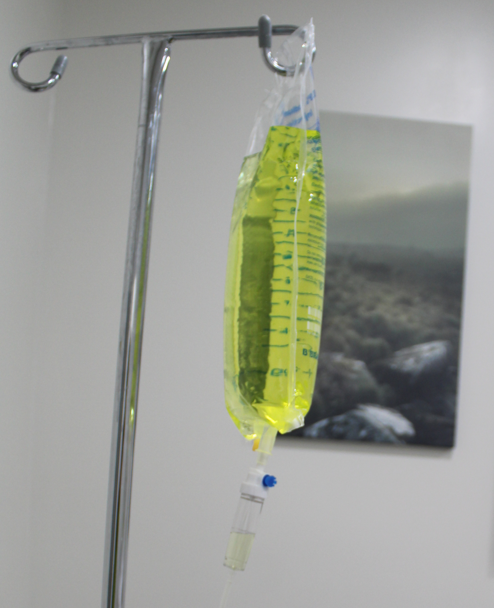 A ziplock bag filled with various fresh fruits including orange, apple, kiwi, and berries, with water splashing around it.