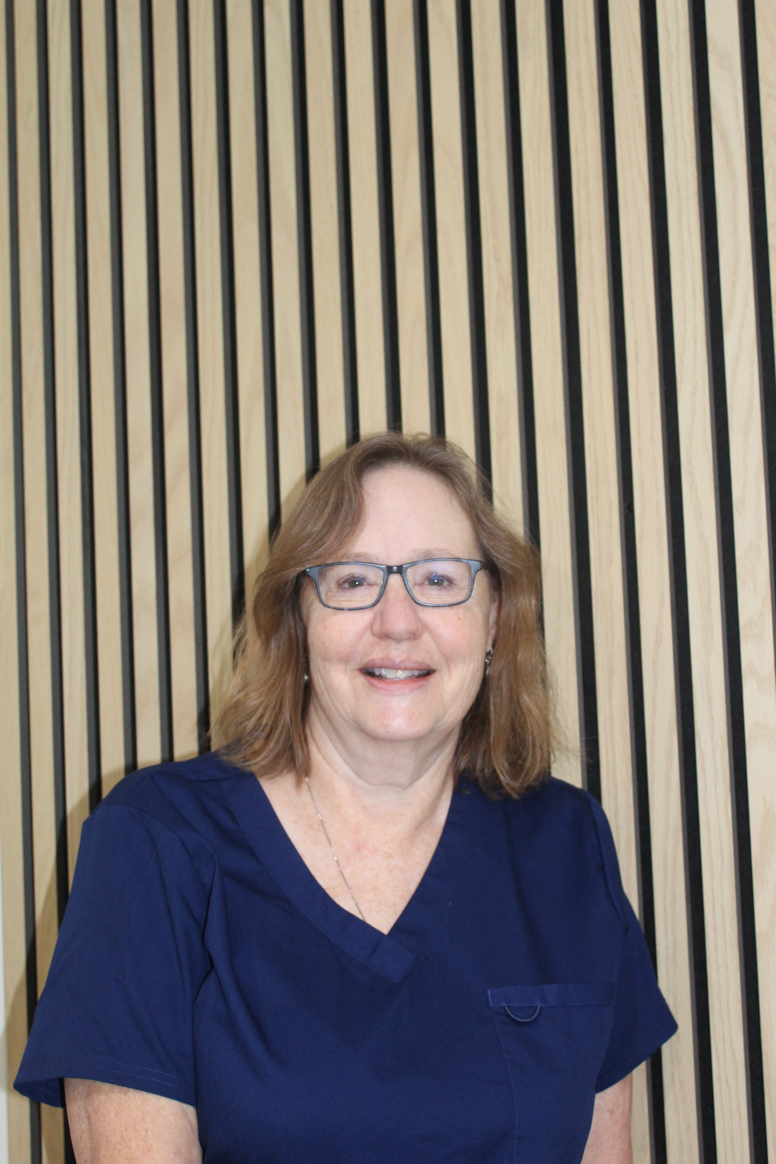 Two people holding hands, one with light skin and the other with darker skin, with sunlight highlighting their hands.