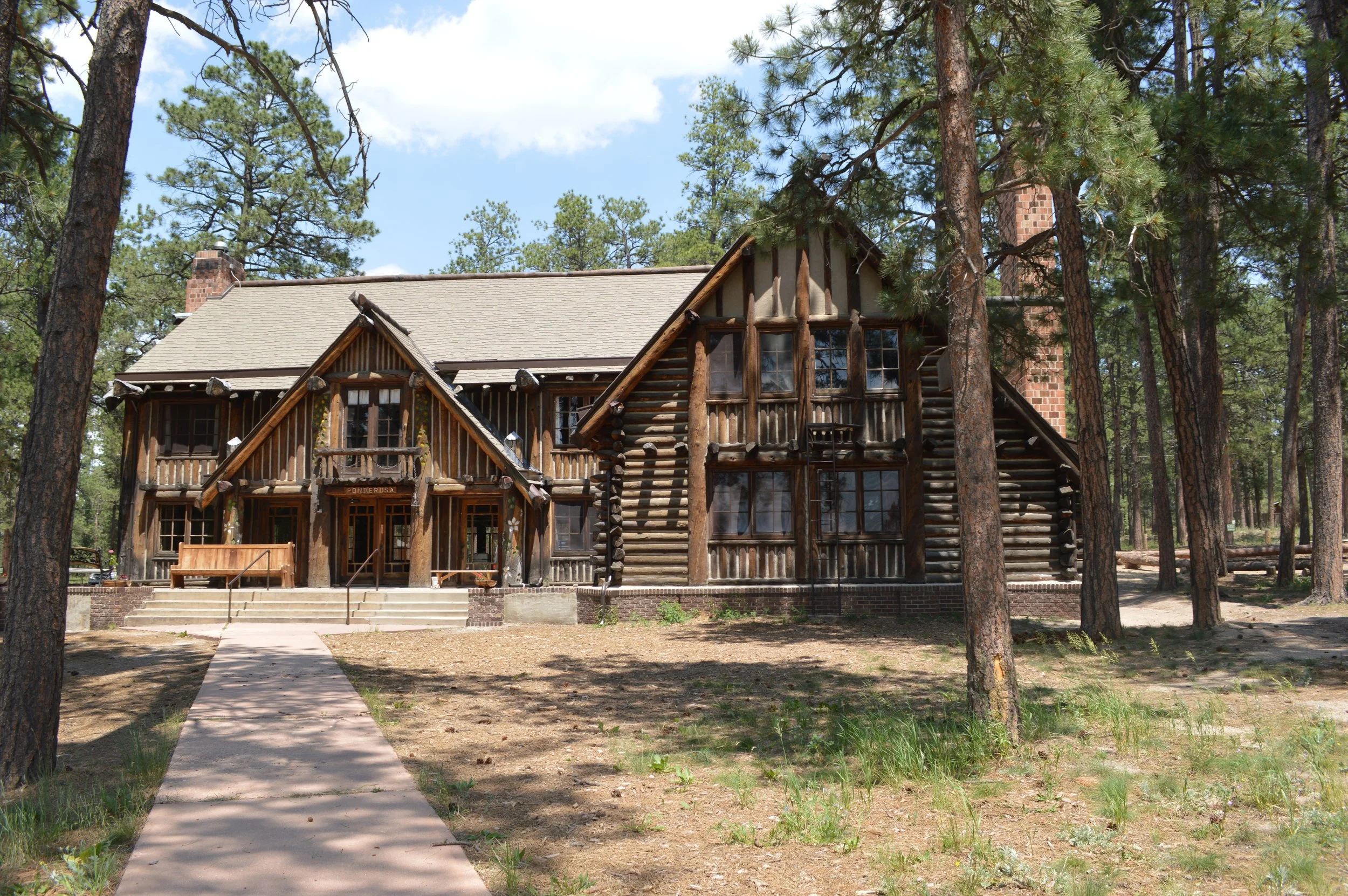 A chalet-style lodge nestled into pine trees at Creepaway Camp - La Foret Retreat Center.