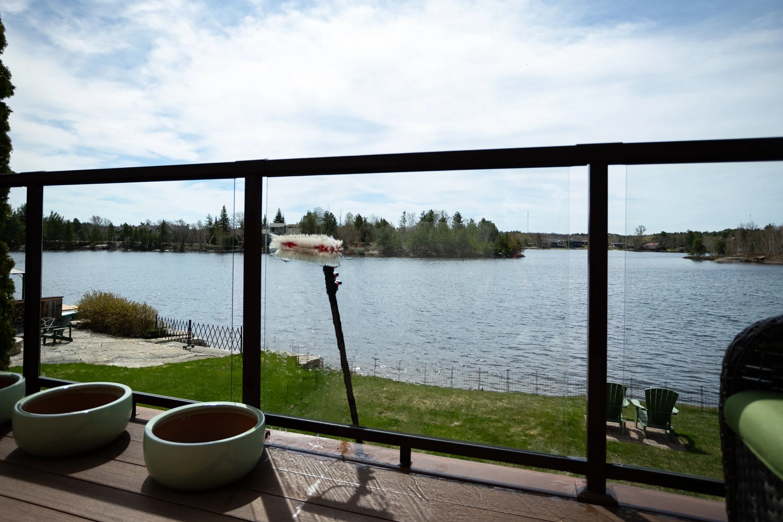 Renew Property Services cleaning deck glass on waterfront home.jpg