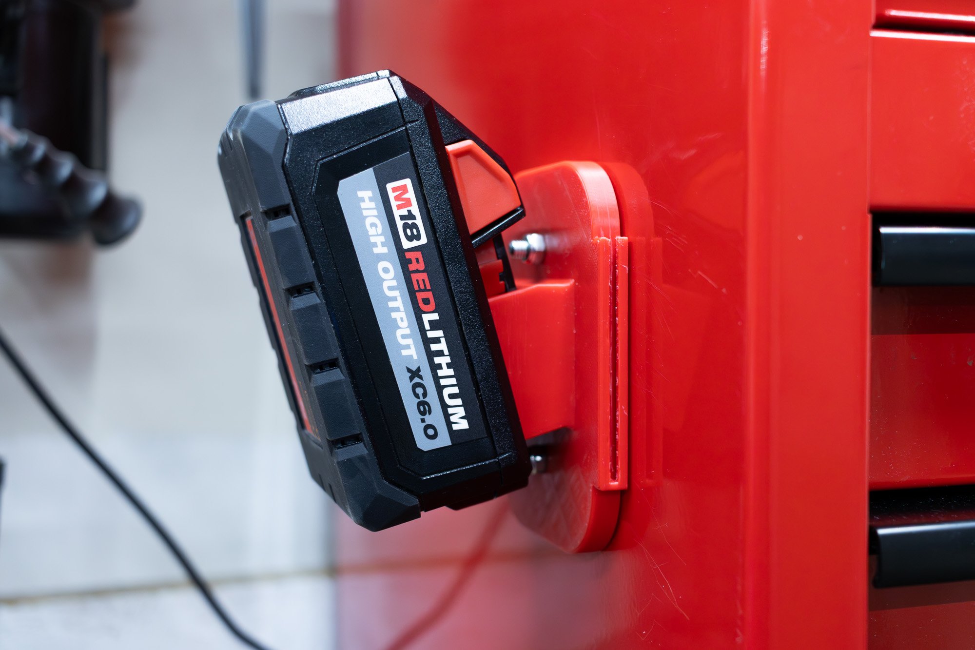 Milwaukee M18 High Output XC6.0 Battery on Magnetic Holder Magnetized to the side of a Toolbox