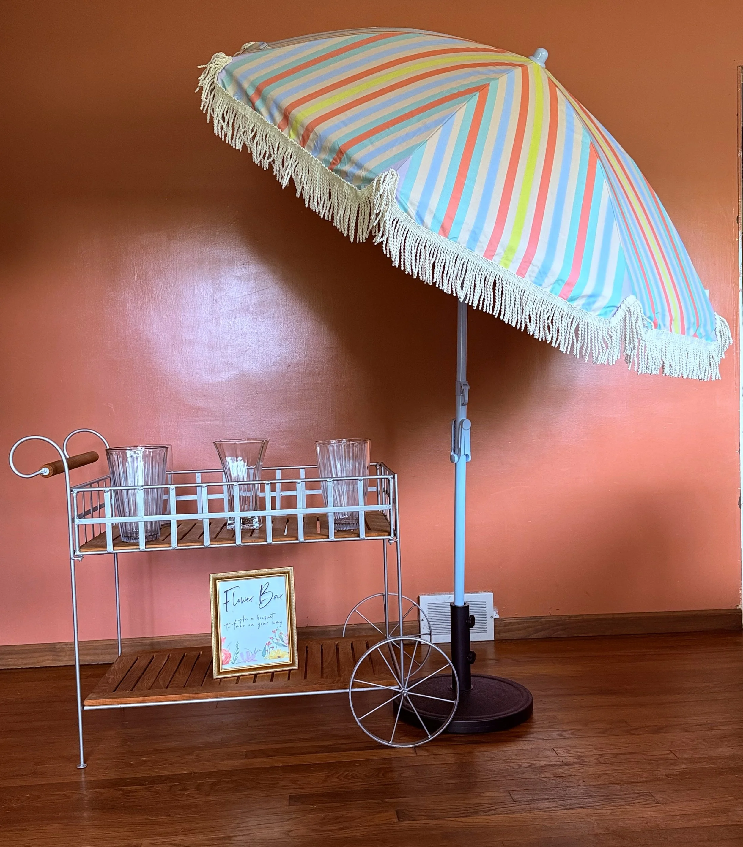 This adorable flower bar is perfect for any occasion, whether it's a birthday party, wedding, or just a fun day out with friends. With its colorful sign and charming design, it's sure to be the talk of the town.