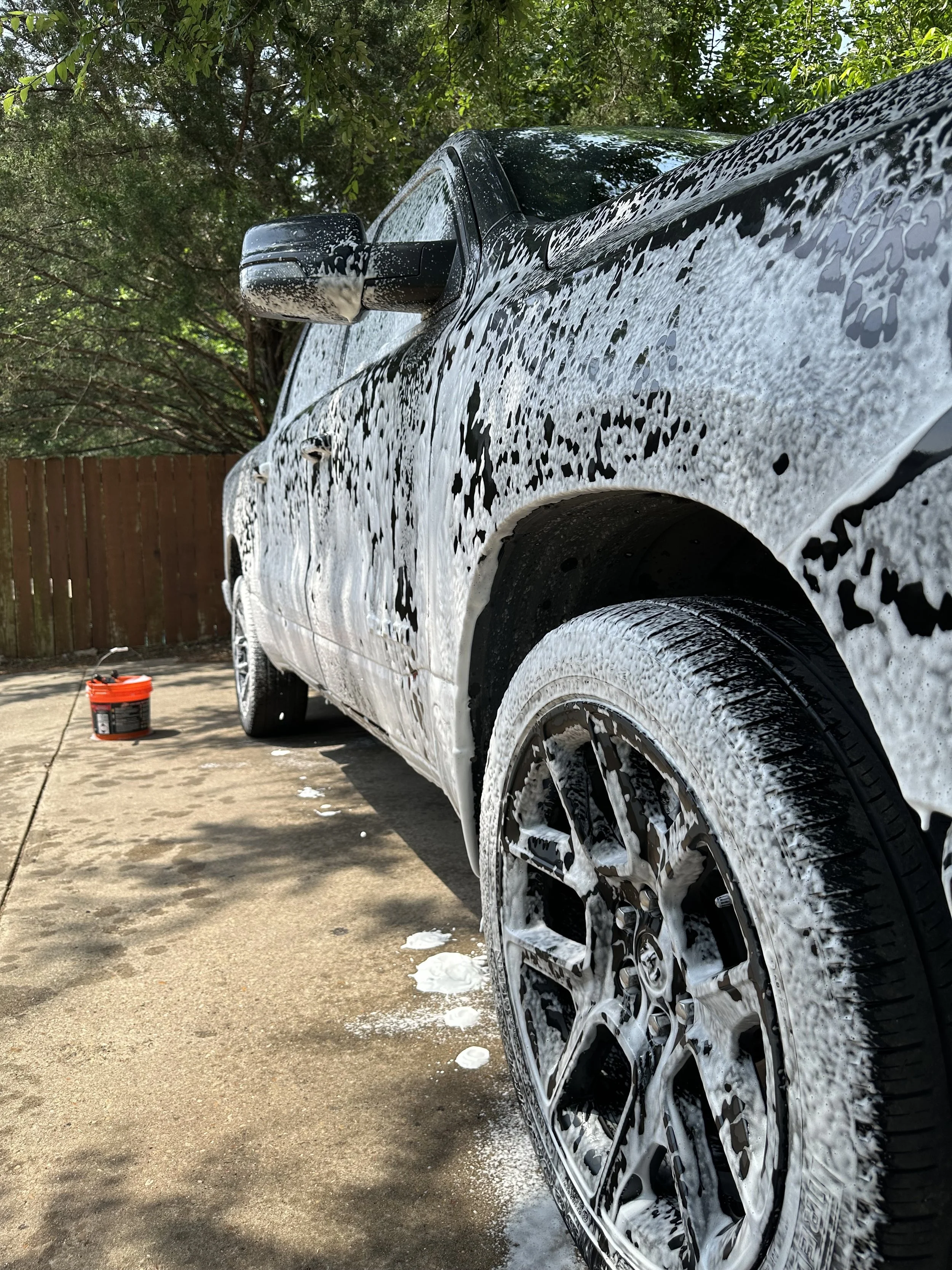Pristine Polish spraying snow foam on truck before hand wash in Waxahachie TX