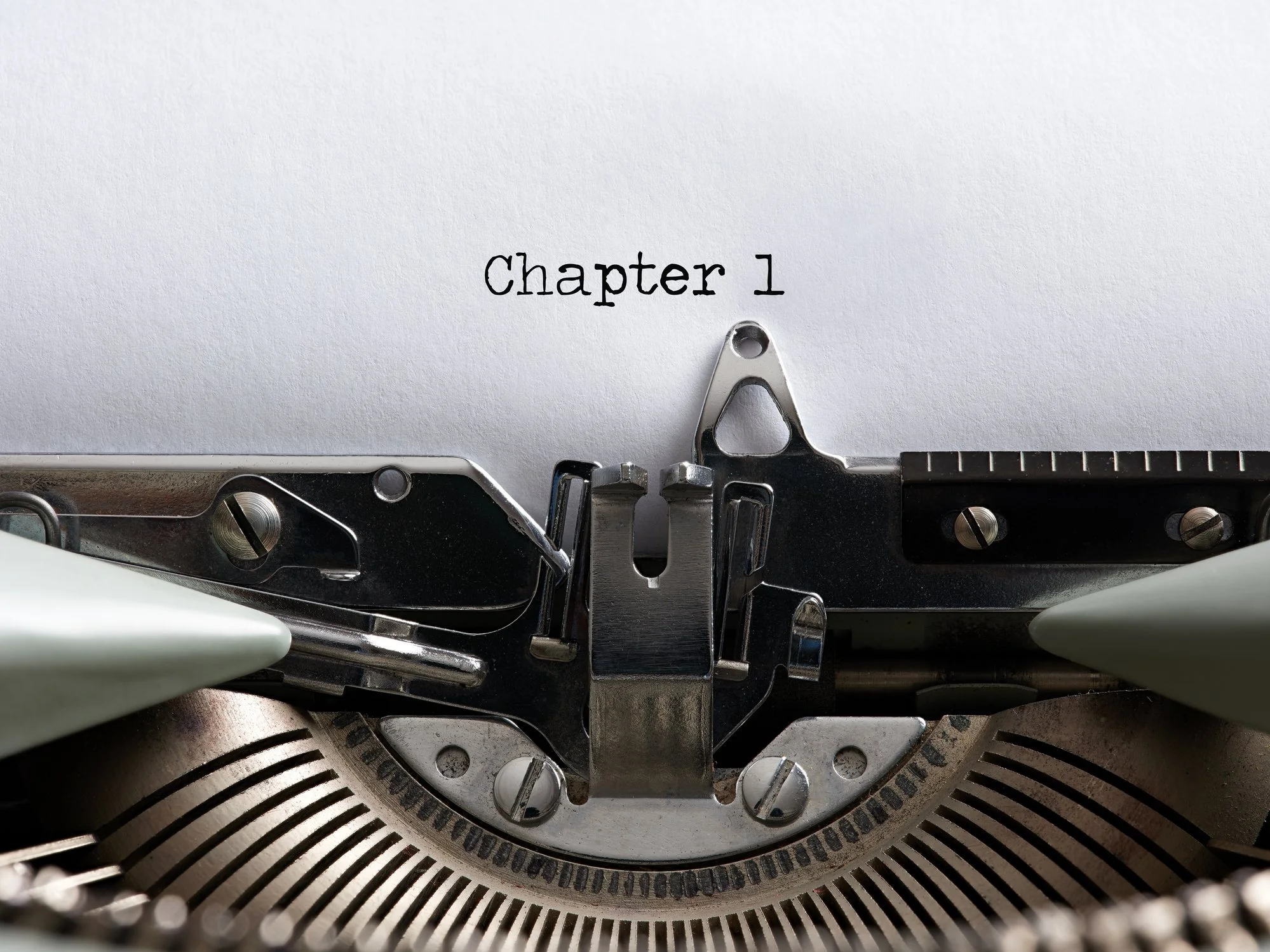 Chapter one text on a blank page typed by an old typewriter