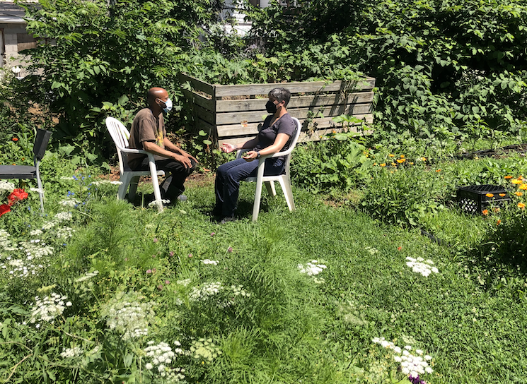 Group members converse in garden chairs with Lee Fogel Somatic Therapist