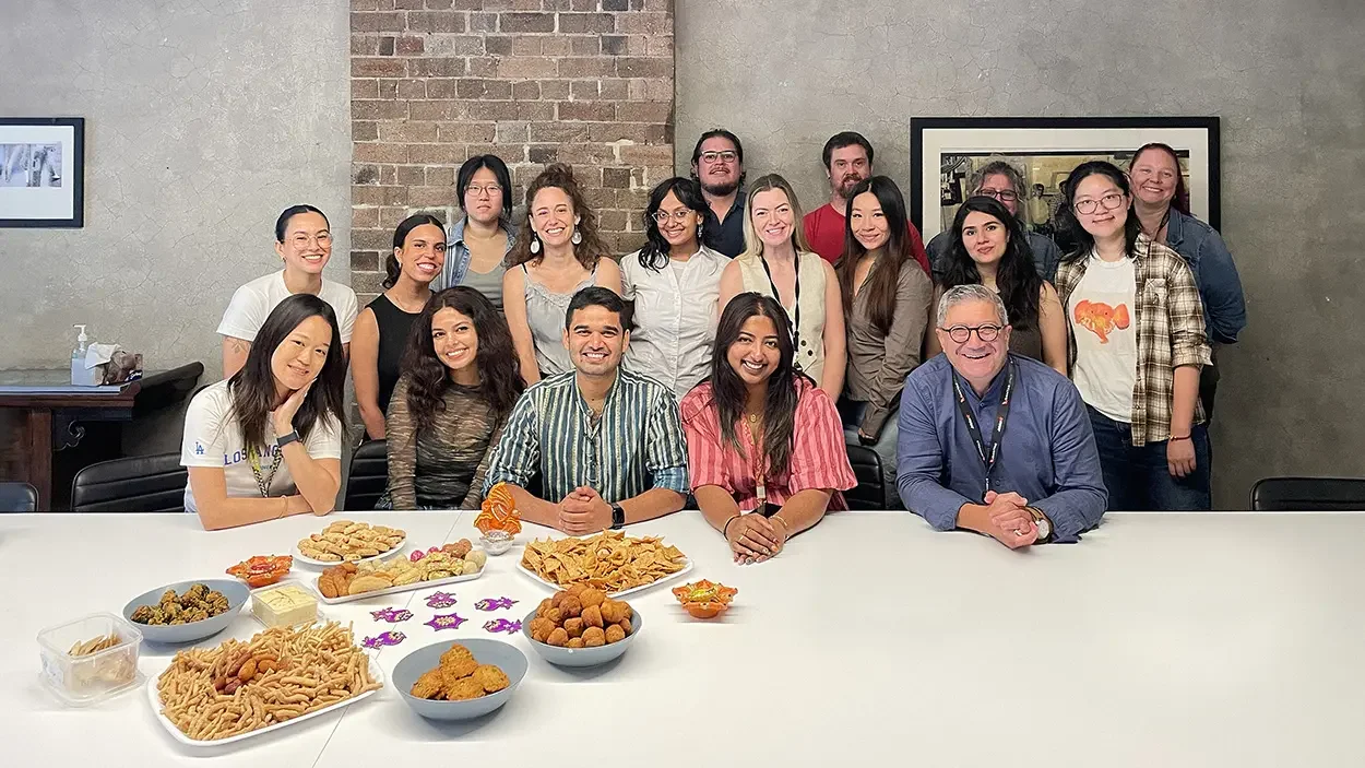 The Cultural Perspectives and CIRCA Research teams posing in front of Diwali treats
